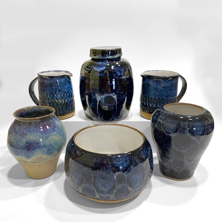 Deep blue jugs, jars, vases and a bowl grouped together