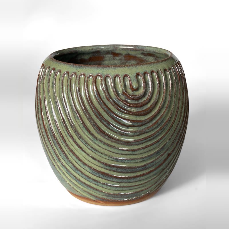 Round green vessel carved with deep concentric arches