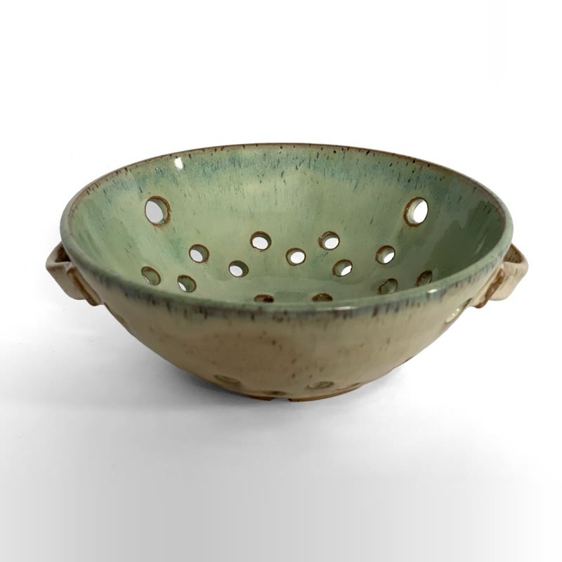 Pale green berry bowl with handles and drainage holes