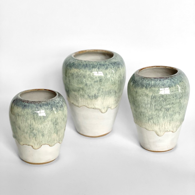 Three small vases with green glaze dripping over white