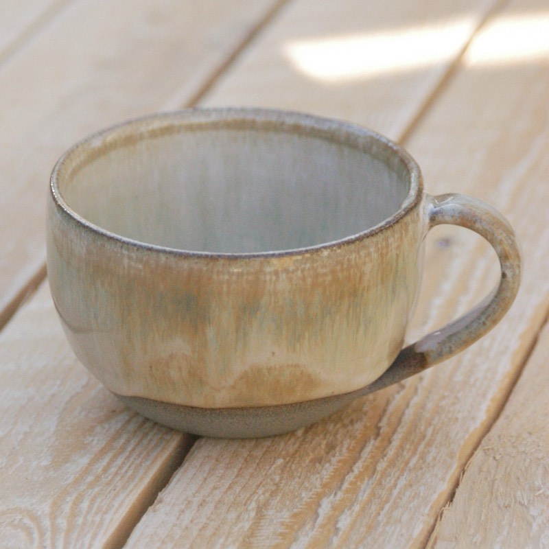 Iron lustre cappuccino cup on a weathered wooden table