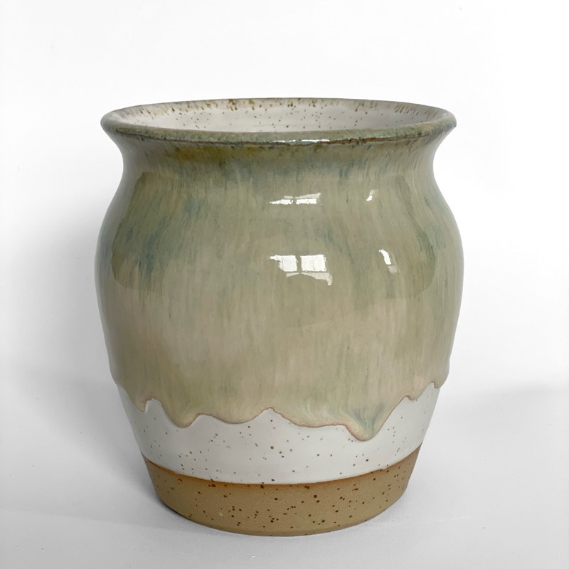 Iron lustre vase with honey and green glaze dripping over a speckled white base