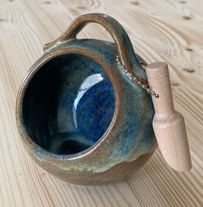 Round blue salt pig with a handle and a little wooden spoon