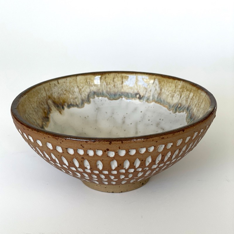 Speckled carved dot bowl with an iron lustre glaze pooling inside