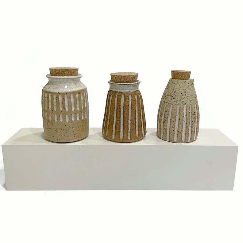 Three speckled bud vases with cork stoppers